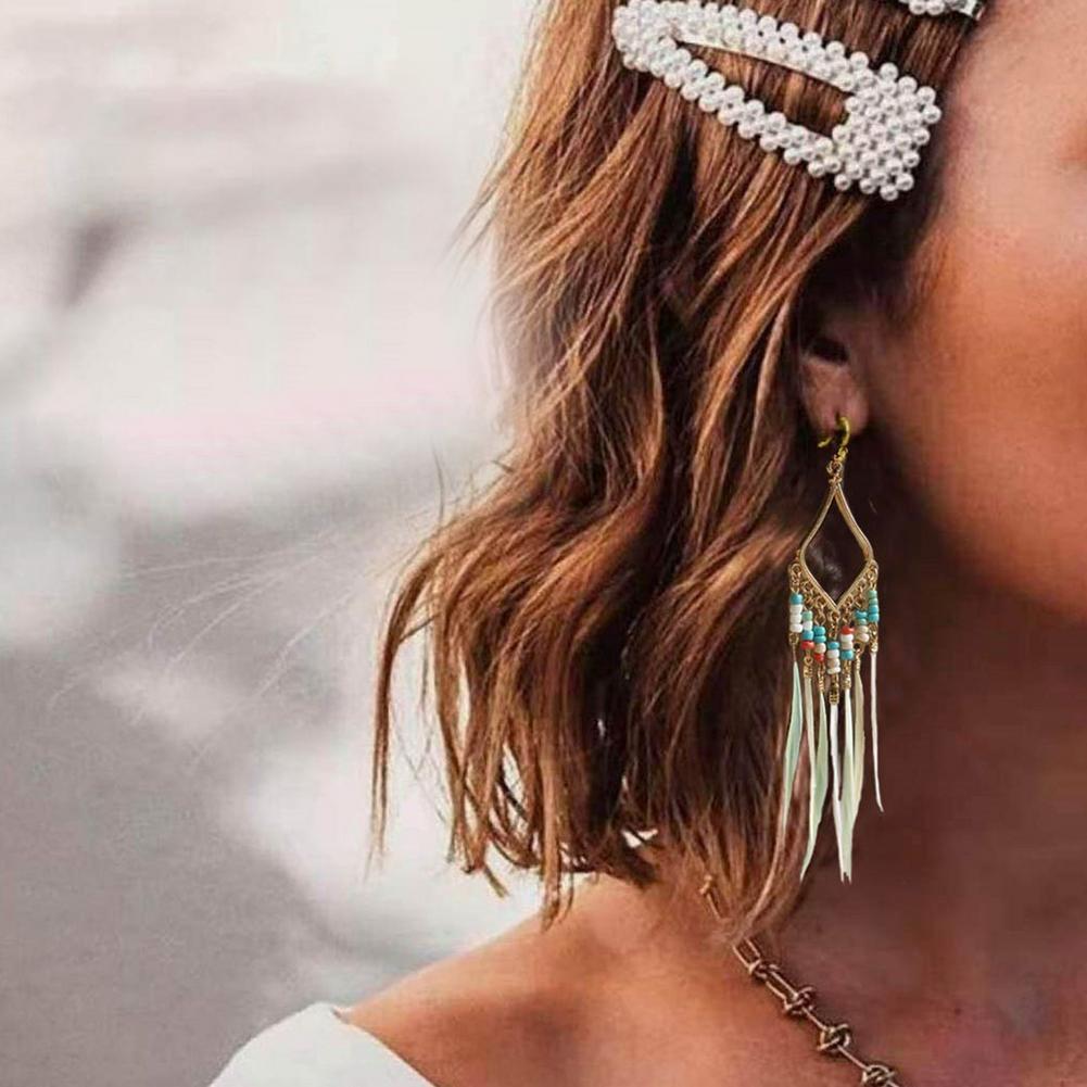 Boucles d'oreilles plumes à pompons